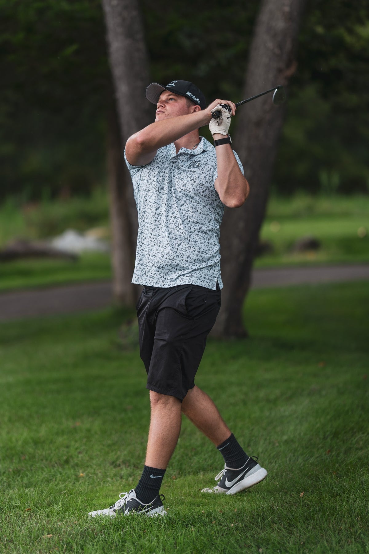 Golfer finishing a swing on the course