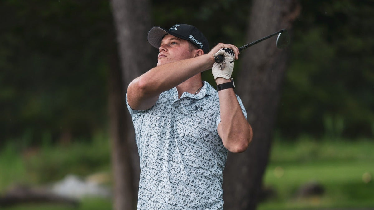 Golfer in a Mathew John Golf polo finishing a tee shot